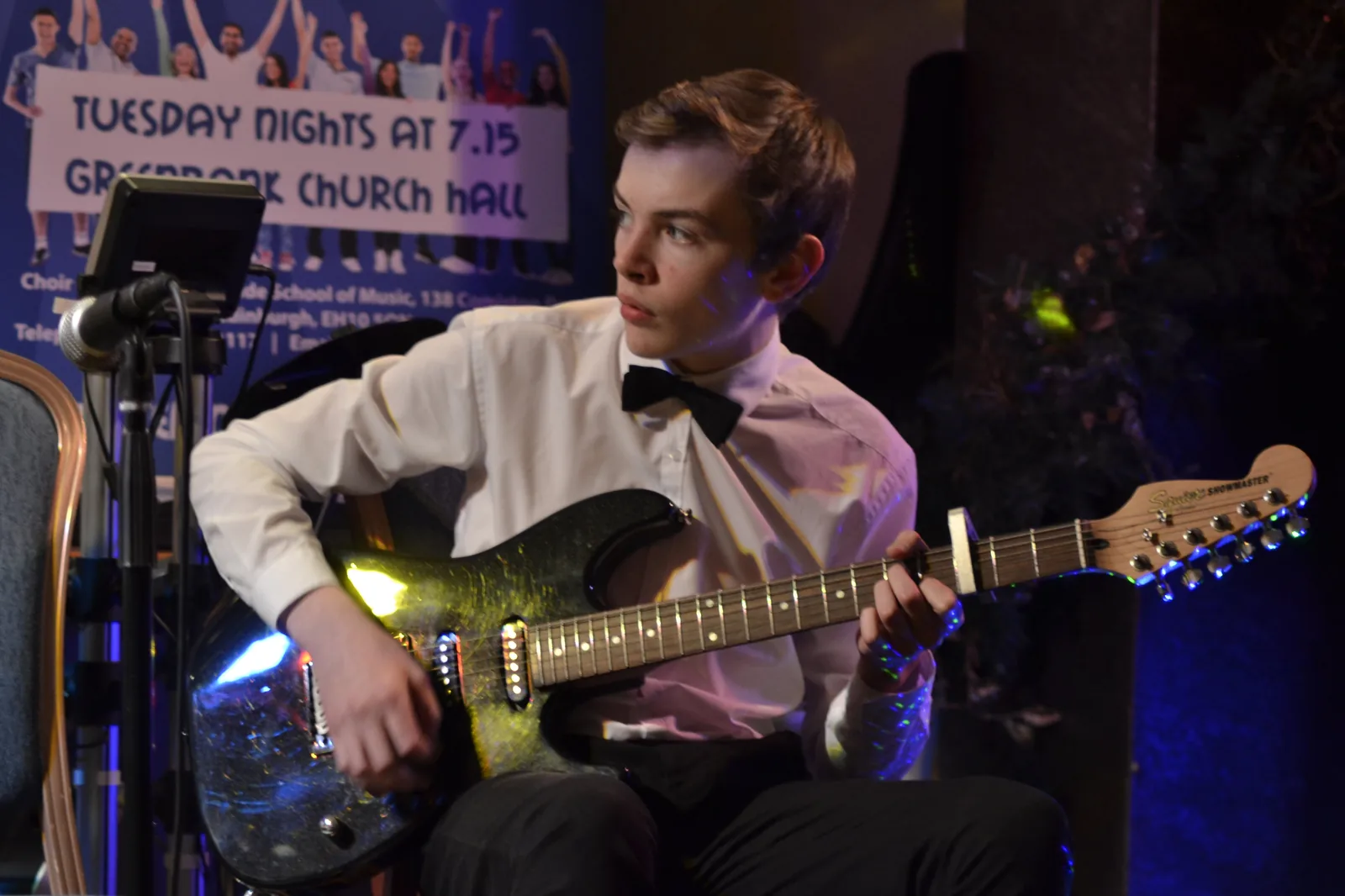 A Morningside School of Music student performing electric guitar at a charity concert in Greenbank Church Hall