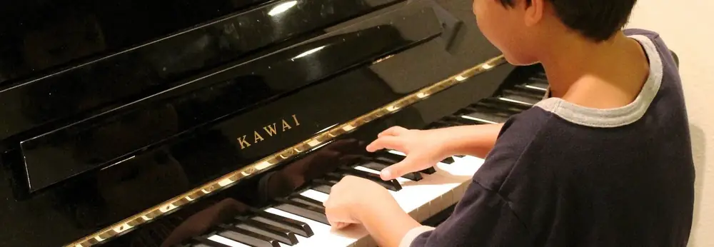 Close-up of a student's hands practising piano scales during a lesson at Morningside School of Music, Edinburgh