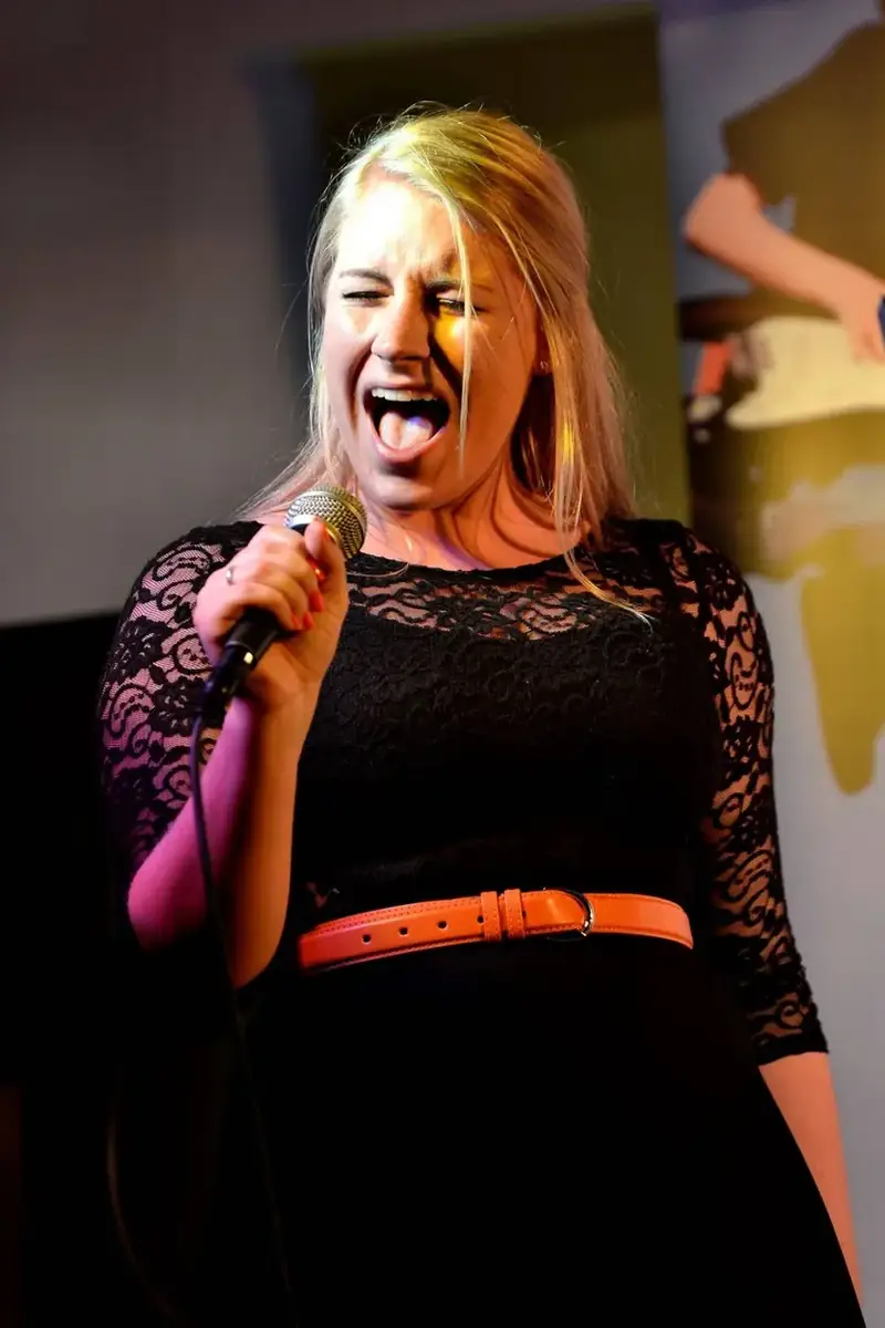 An adult singing student performing live at a Morningside School of Music showcase in Edinburgh