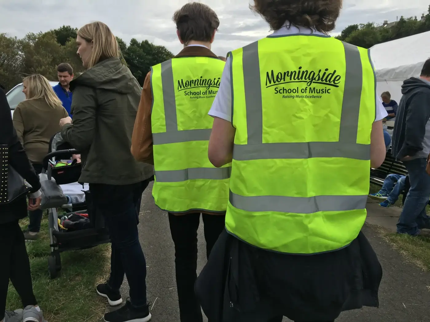 Morningside School of Music volunteers in branded hi-vis vests supervising a community charity event