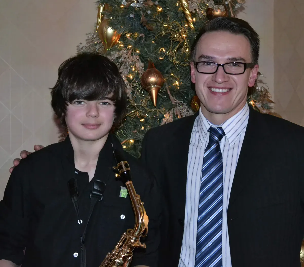 A Morningside music teacher with a saxophone student at a school performance